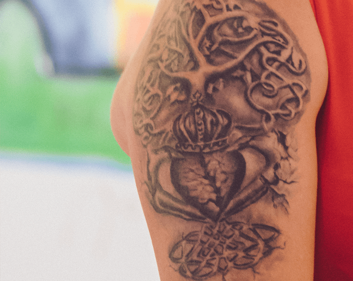 [Anon is a female in her 50s with a tattoo on her upper right arm containing a Claddagh and the Celtic tree of life. A Claddagh is a symbol of two hands holding a heart topped by a crown. In Anon’s tattoo, the heart is ripped in half and is being held together by two hands that represent her friends and family.]
